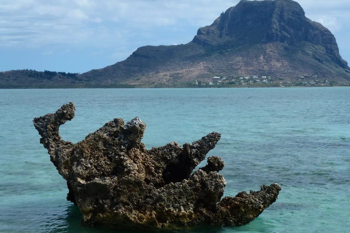 A rock in the turquoise lagoon below Le Morne Brabant in Mauritius