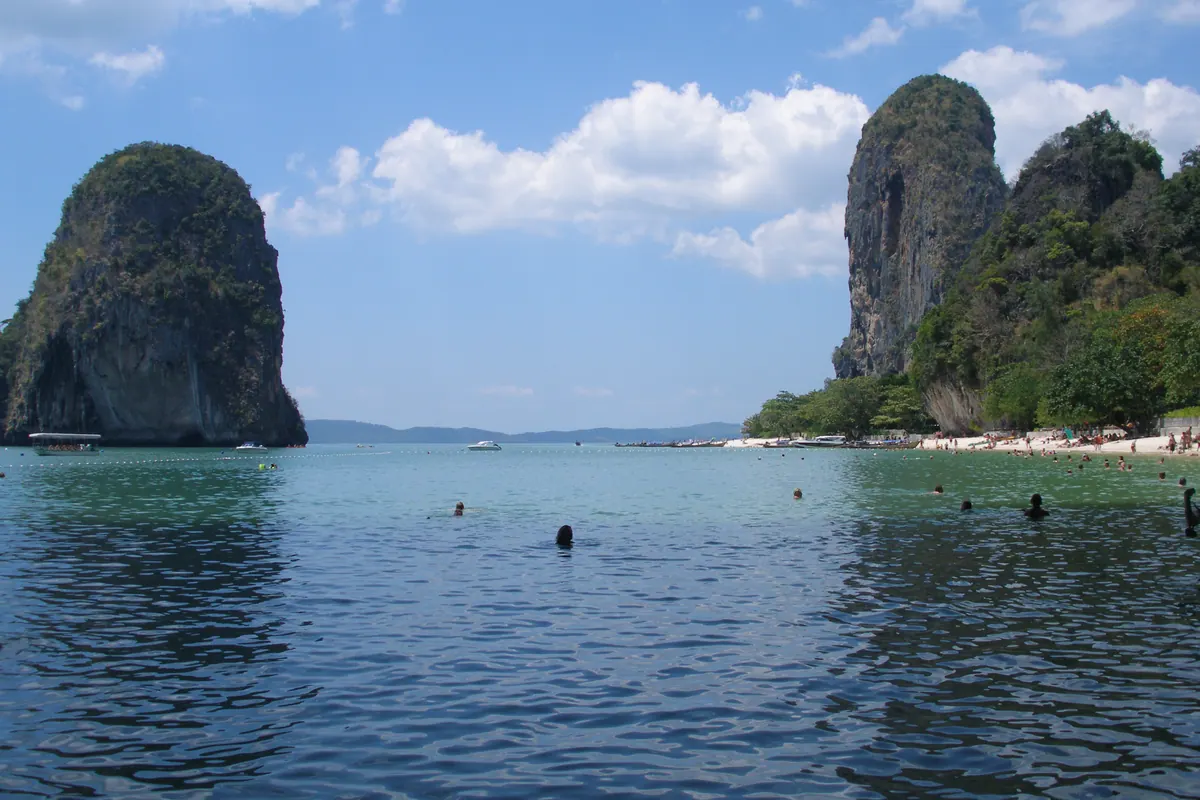 Limestone cliffs rising from clear sea at Railay beach in Krabi, Thailand