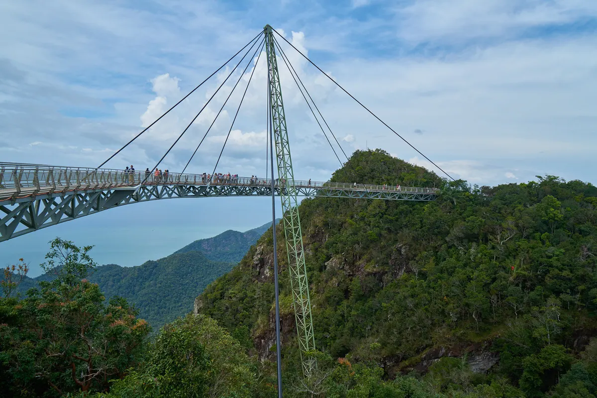 The curved Langkawi Sky Bridge suspended above forested limestone peaks